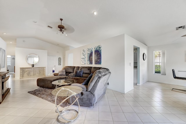 tiled living room featuring ceiling fan and vaulted ceiling