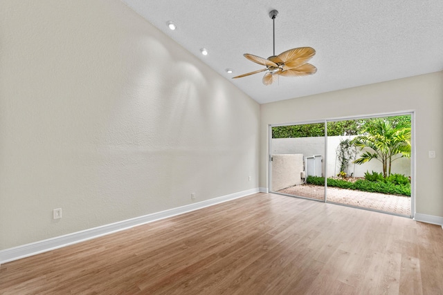 unfurnished room featuring a textured ceiling, high vaulted ceiling, ceiling fan, and light hardwood / wood-style flooring