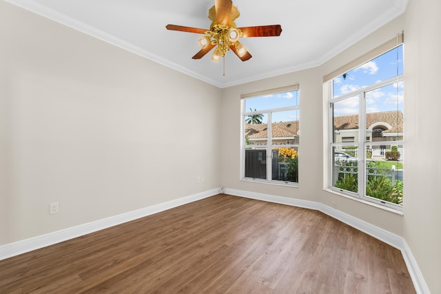 unfurnished room featuring crown molding, dark hardwood / wood-style floors, and ceiling fan