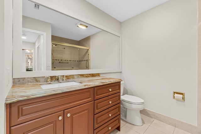 bathroom featuring toilet, tile floors, and vanity