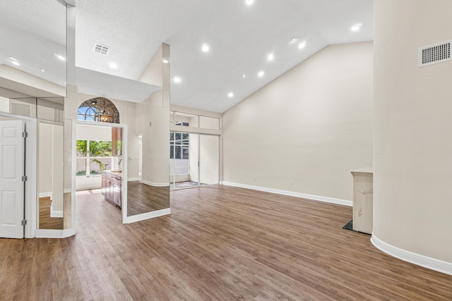 interior space featuring high vaulted ceiling and wood-type flooring