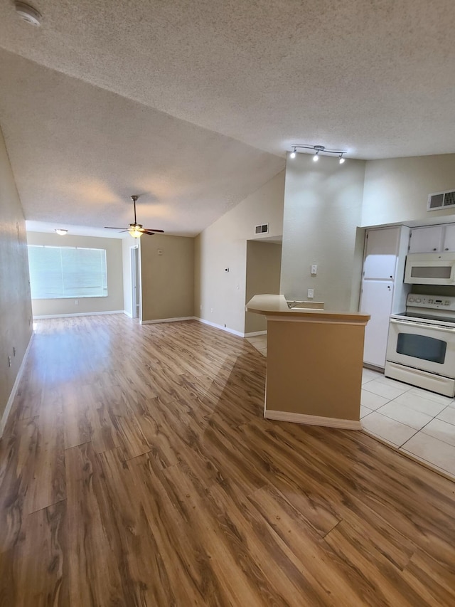 kitchen featuring white appliances, ceiling fan, track lighting, and light wood-type flooring