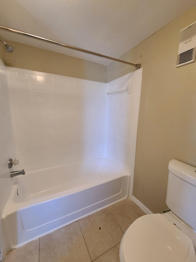 bathroom featuring toilet, tile floors, and bathtub / shower combination