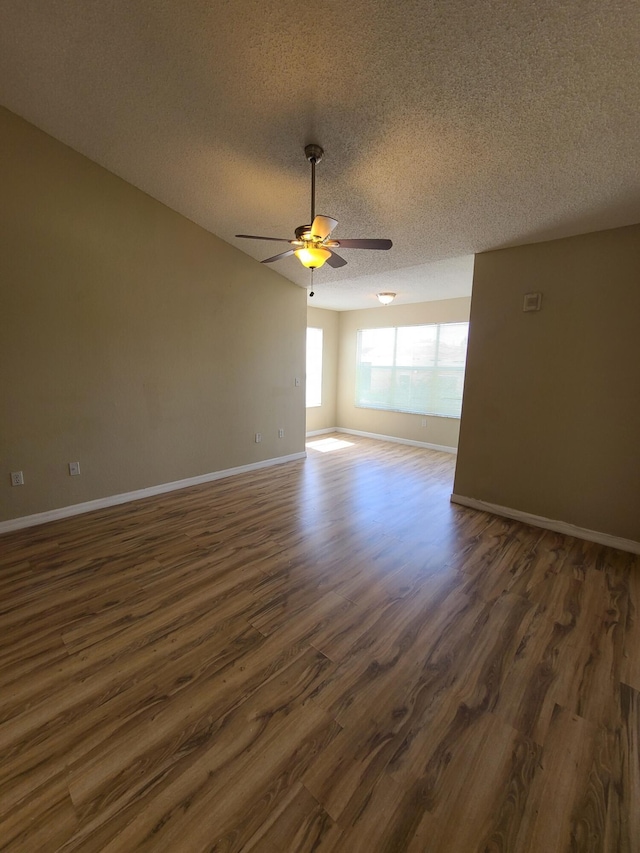 unfurnished room with ceiling fan, a textured ceiling, and dark hardwood / wood-style flooring