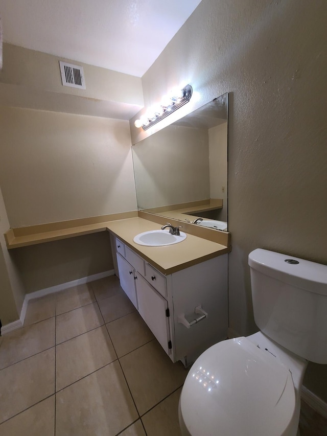 bathroom featuring tile floors, toilet, and vanity