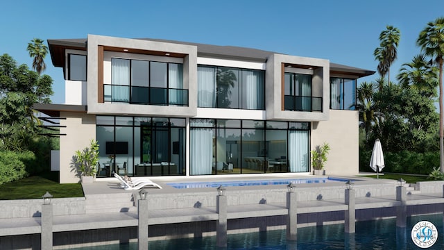 rear view of house with a fenced in pool and a patio