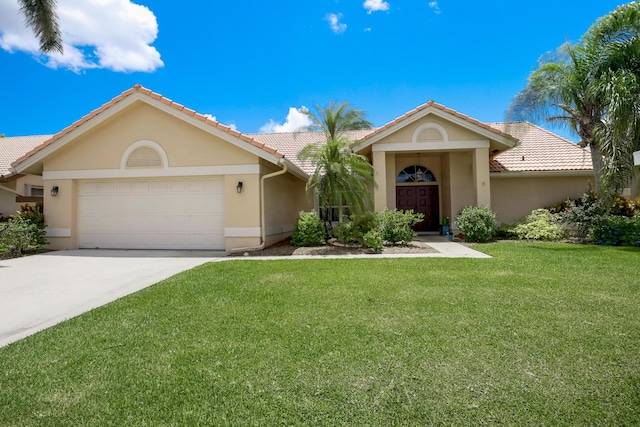 ranch-style home featuring a front lawn and a garage