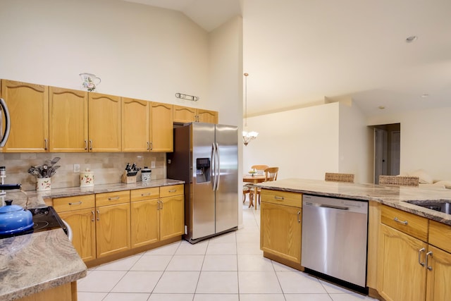 kitchen with a notable chandelier, high vaulted ceiling, stainless steel appliances, light tile floors, and tasteful backsplash