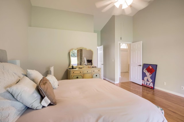 bedroom with high vaulted ceiling, ceiling fan, and light hardwood / wood-style flooring