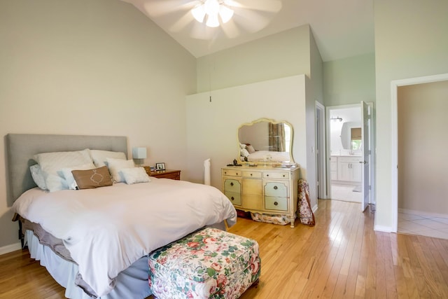 bedroom with light tile floors, ensuite bath, ceiling fan, and high vaulted ceiling