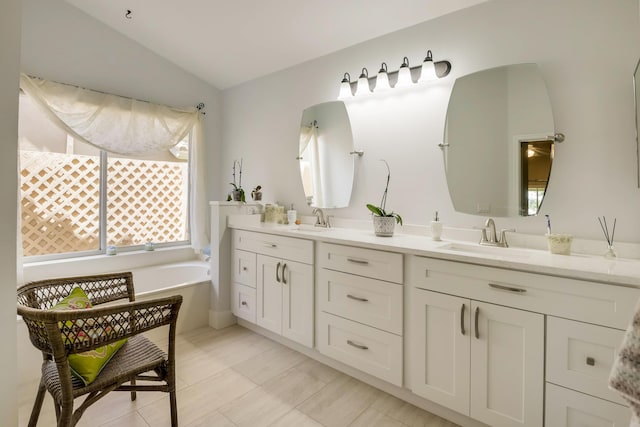 bathroom featuring tile floors, vaulted ceiling, dual vanity, and a bath to relax in