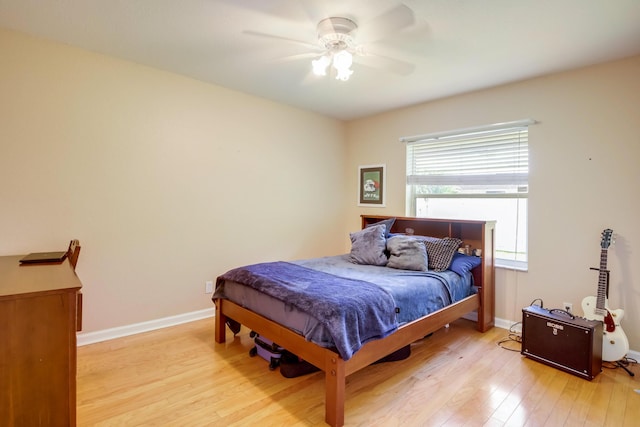 bedroom with ceiling fan and light hardwood / wood-style flooring