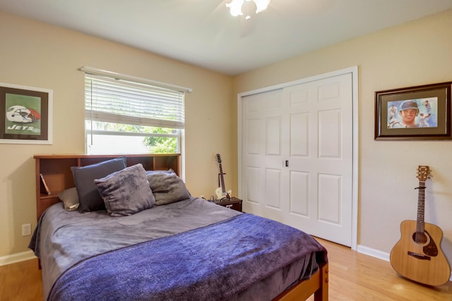 bedroom featuring a closet, ceiling fan, and light wood-type flooring