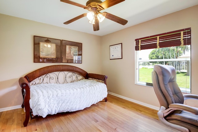 bedroom with light hardwood / wood-style floors and ceiling fan