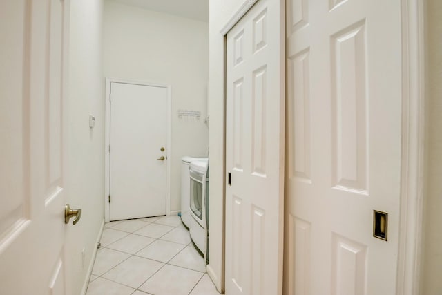 laundry area with washer and dryer and light tile floors