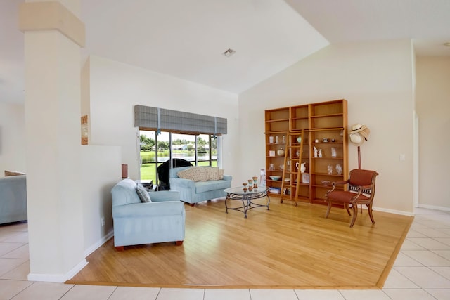 living room featuring light hardwood / wood-style floors and high vaulted ceiling