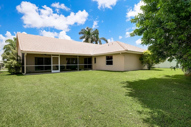 back of property with a lawn