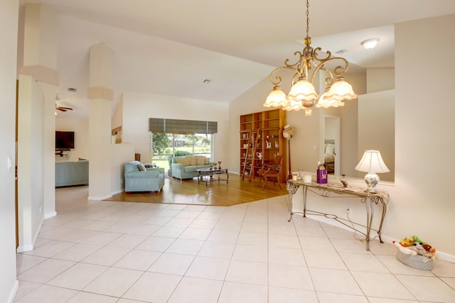 interior space with light tile floors, a notable chandelier, and high vaulted ceiling