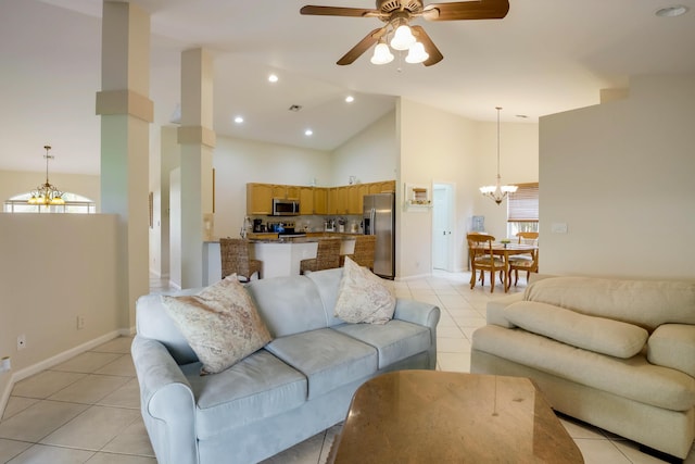 tiled living room featuring high vaulted ceiling and ceiling fan with notable chandelier