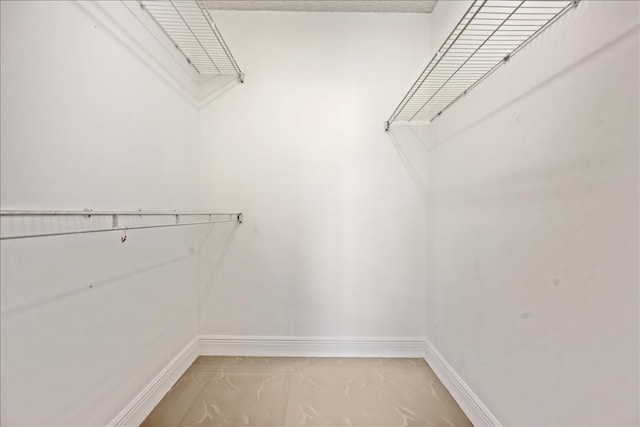 spacious closet featuring light tile floors