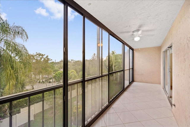 unfurnished sunroom with ceiling fan