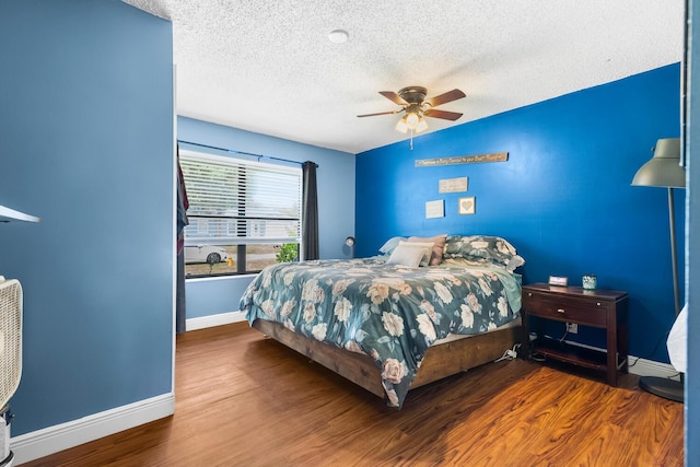 bedroom featuring a textured ceiling, ceiling fan, dark wood-type flooring, and lofted ceiling