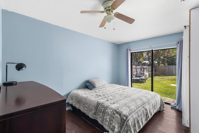 bedroom with access to outside, ceiling fan, and dark wood-type flooring