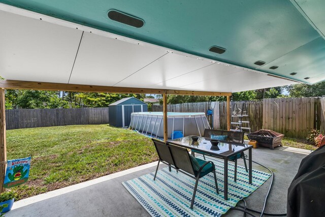 view of terrace featuring a storage unit and a fire pit