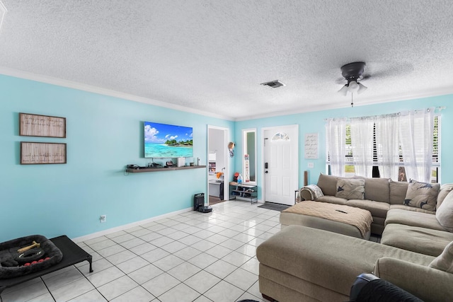 tiled living room with a textured ceiling, ceiling fan, and ornamental molding