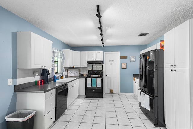 kitchen featuring light tile floors, a textured ceiling, tasteful backsplash, black appliances, and white cabinets