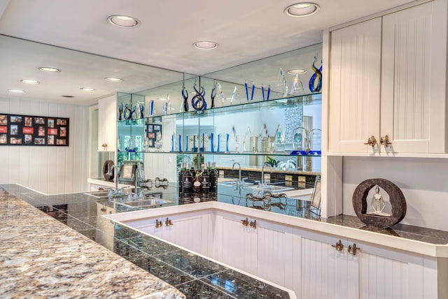 bar with sink and white cabinets