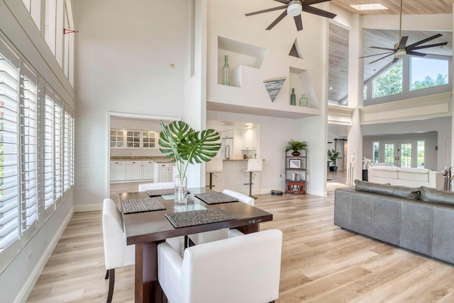 dining area featuring a high ceiling and light wood-type flooring