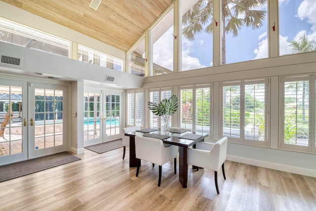 sunroom / solarium featuring french doors, wood ceiling, and plenty of natural light