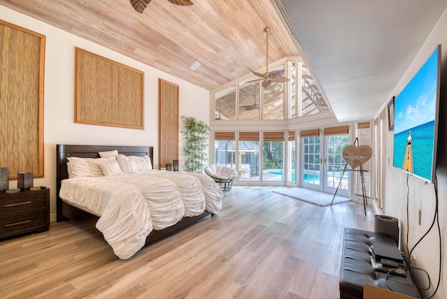 bedroom featuring access to exterior, a towering ceiling, light hardwood / wood-style flooring, and wooden ceiling