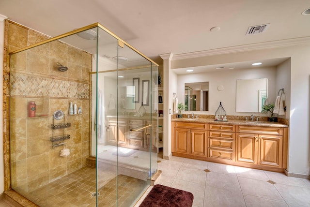 bathroom with tile patterned floors, vanity, an enclosed shower, and ornamental molding