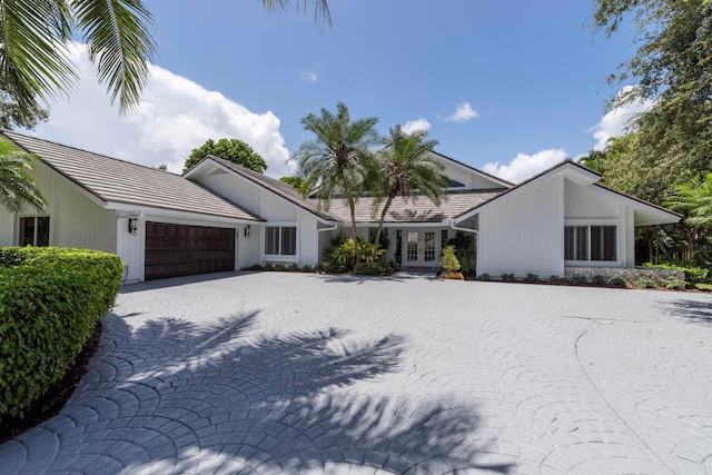 view of front of house with a garage and french doors