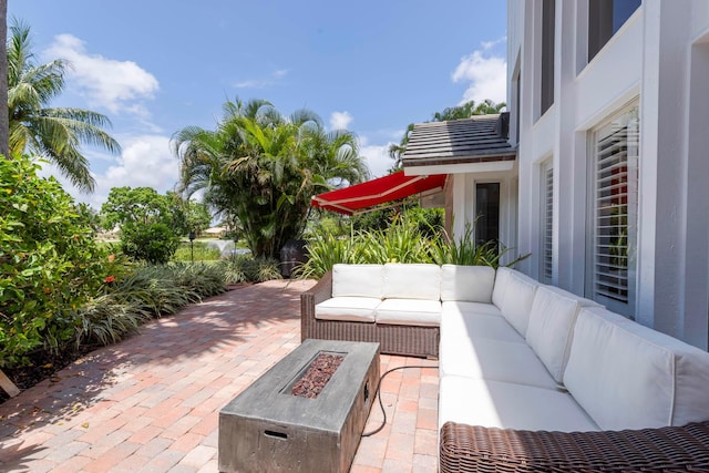 view of patio / terrace featuring an outdoor living space with a fire pit