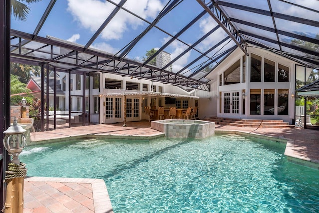 view of swimming pool with french doors, an outdoor bar, pool water feature, an in ground hot tub, and a patio area