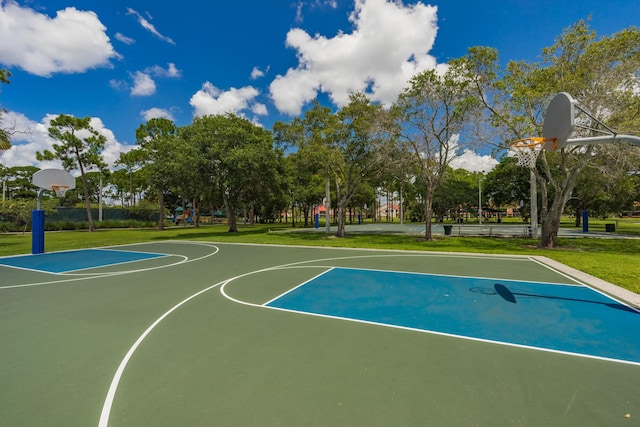 view of basketball court with a lawn