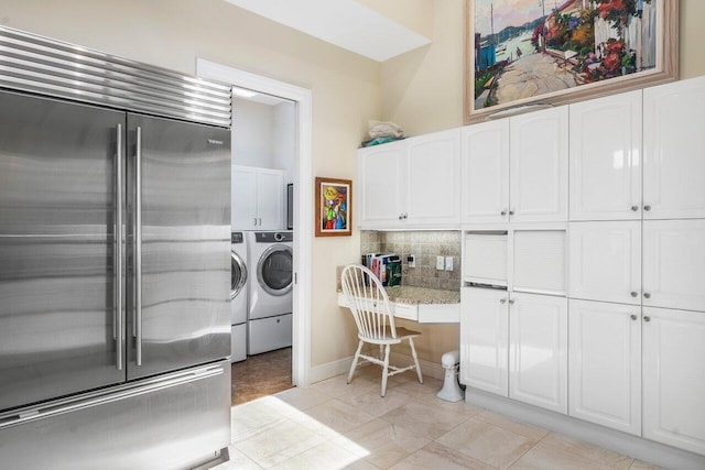 laundry area featuring light tile floors and washing machine and clothes dryer