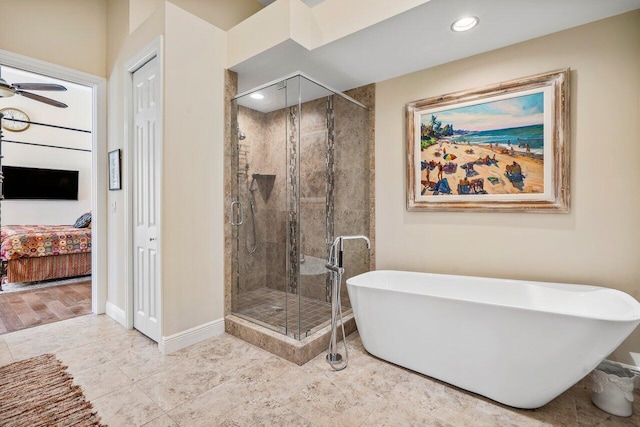 bathroom with tile floors, ceiling fan, and separate shower and tub