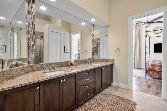 bathroom with tile floors, ceiling fan, and double sink vanity