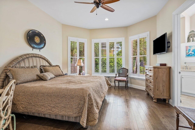 bedroom featuring ceiling fan, dark wood-type flooring, sink, and connected bathroom