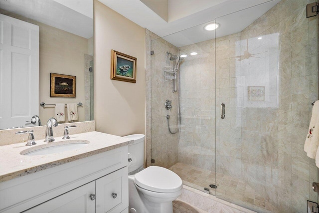 bathroom featuring an enclosed shower, oversized vanity, and toilet