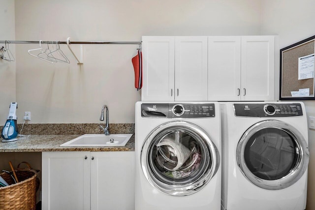 laundry room featuring cabinets, separate washer and dryer, and sink