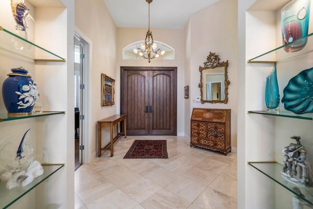 entrance foyer with a notable chandelier and light tile flooring