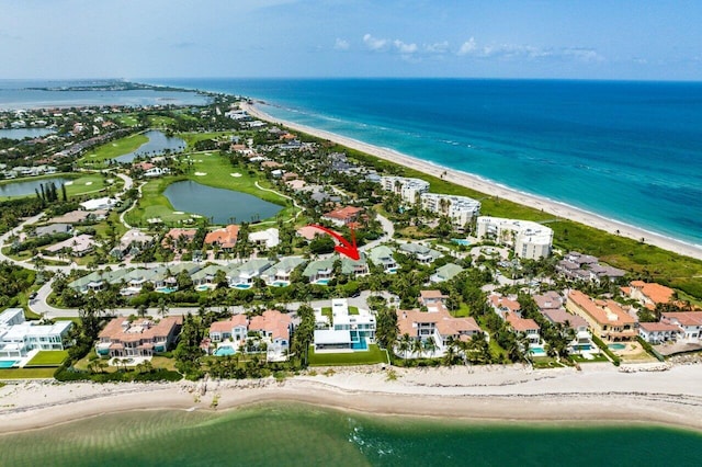 drone / aerial view featuring a beach view and a water view