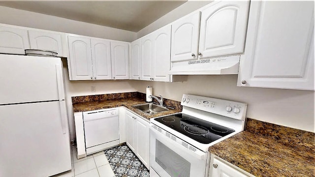 kitchen with sink, white appliances, light tile patterned floors, and white cabinets