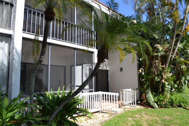 view of home's exterior with a sunroom