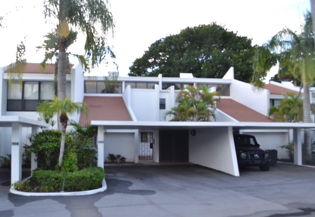 view of front of home featuring a garage and a carport